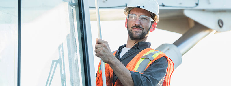 Crane Operator outside cab of mobile crane