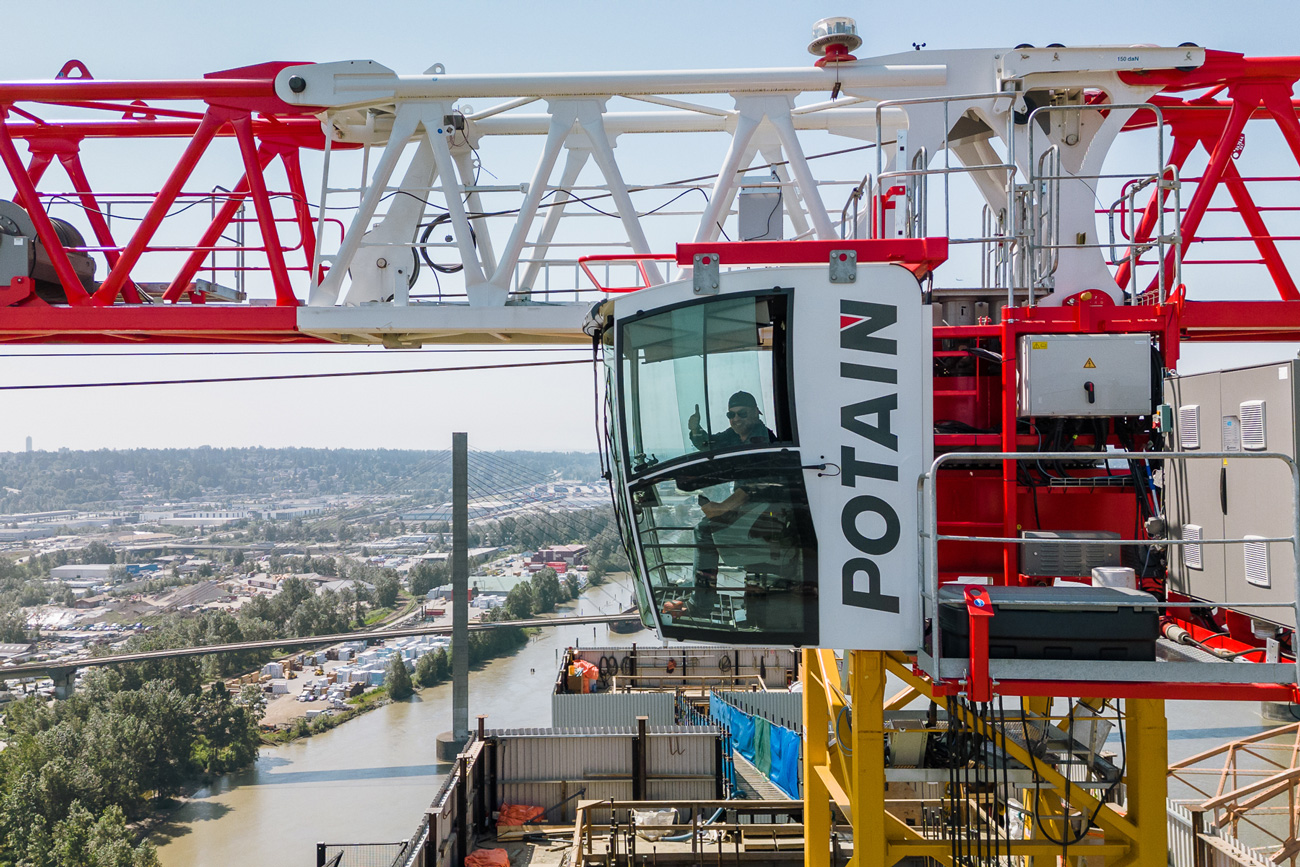 crane operation as a career: an operator gives a thumbs up from the cab of the crane